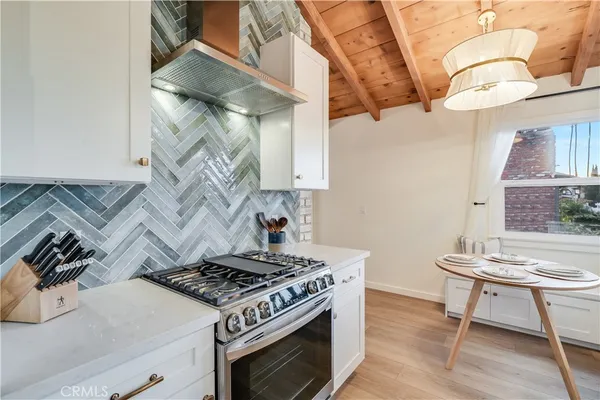 a stove top oven sitting inside of a kitchen