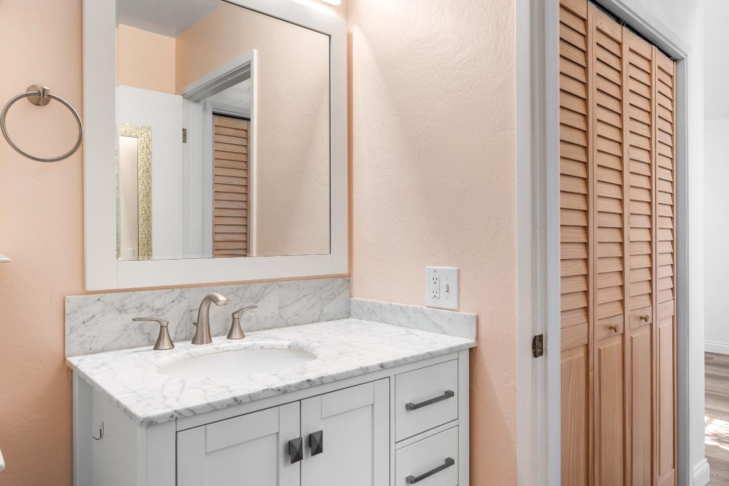 710 Freeman Court Santa Cruz, CA 95062 - Photo 11 of 18 a bathroom with a granite countertop sink and a mirror