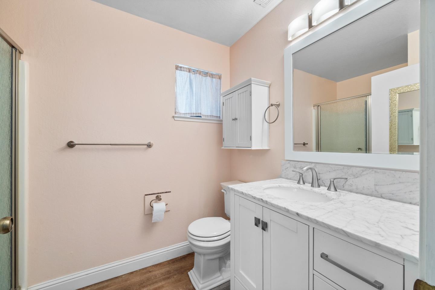 710 Freeman Court Santa Cruz, CA 95062 - Photo 10 of 18 a bathroom with a granite countertop sink a toilet and a mirror