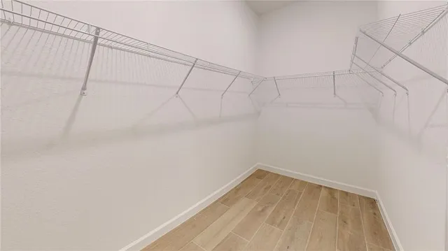 a large kitchen with stainless steel appliances a refrigerator and a stove top oven