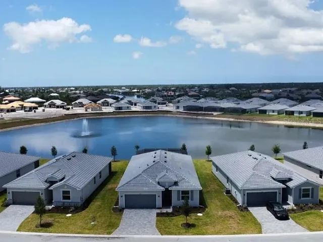 a white toilet sitting next to a white wall