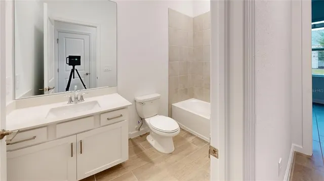a bathroom with a sink toilet vanity and shower