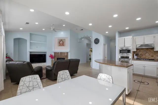 a living room with fireplace furniture and a wooden floor