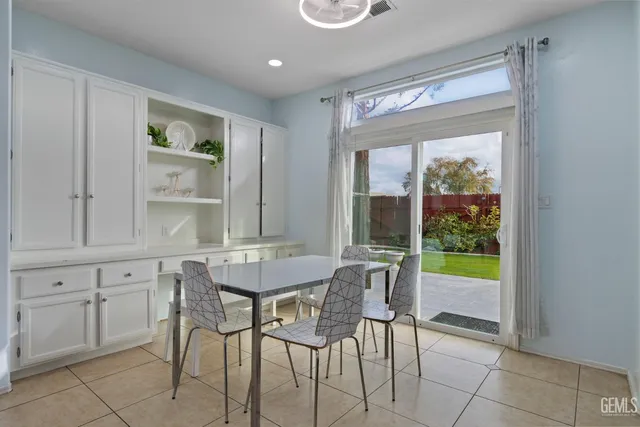 a view of a dining room with furniture and a window