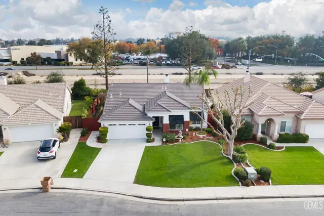 a view of a house with a swimming pool and a yard