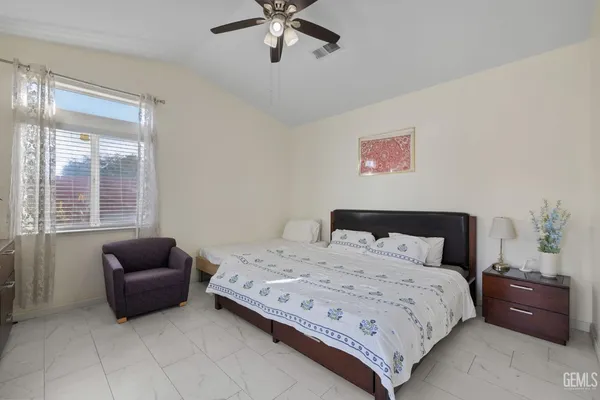a bedroom with a bed and a couch