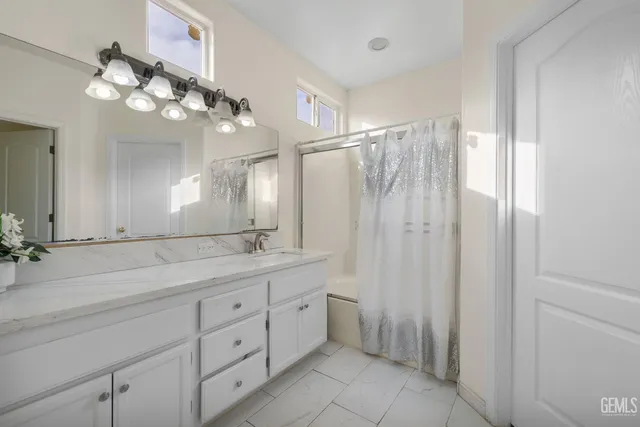 a bathroom with a double vanity sink and a mirror