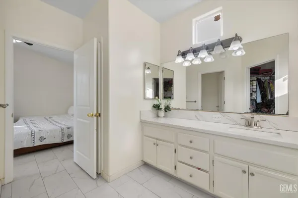 a bathroom with a double vanity sink and a mirror