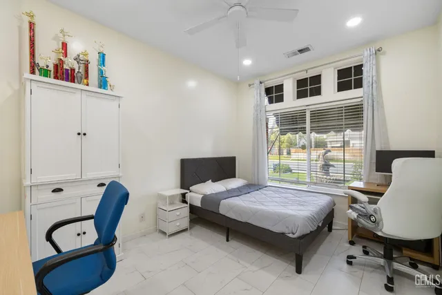 a bedroom with furniture and a window