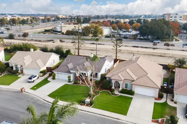an aerial view of a house with garden space and street view