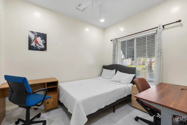 a bedroom with a bed and a desk