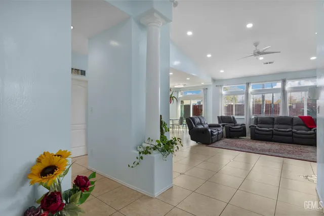 a living room with furniture and flowers