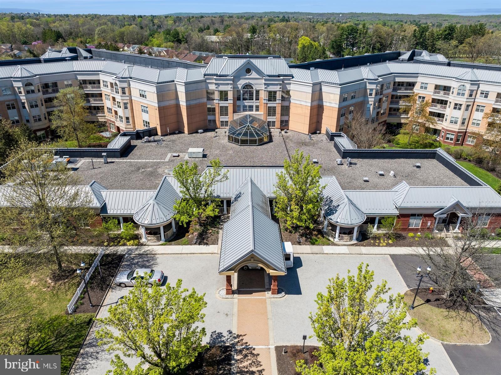 an aerial view of residential houses with outdoor space and parking