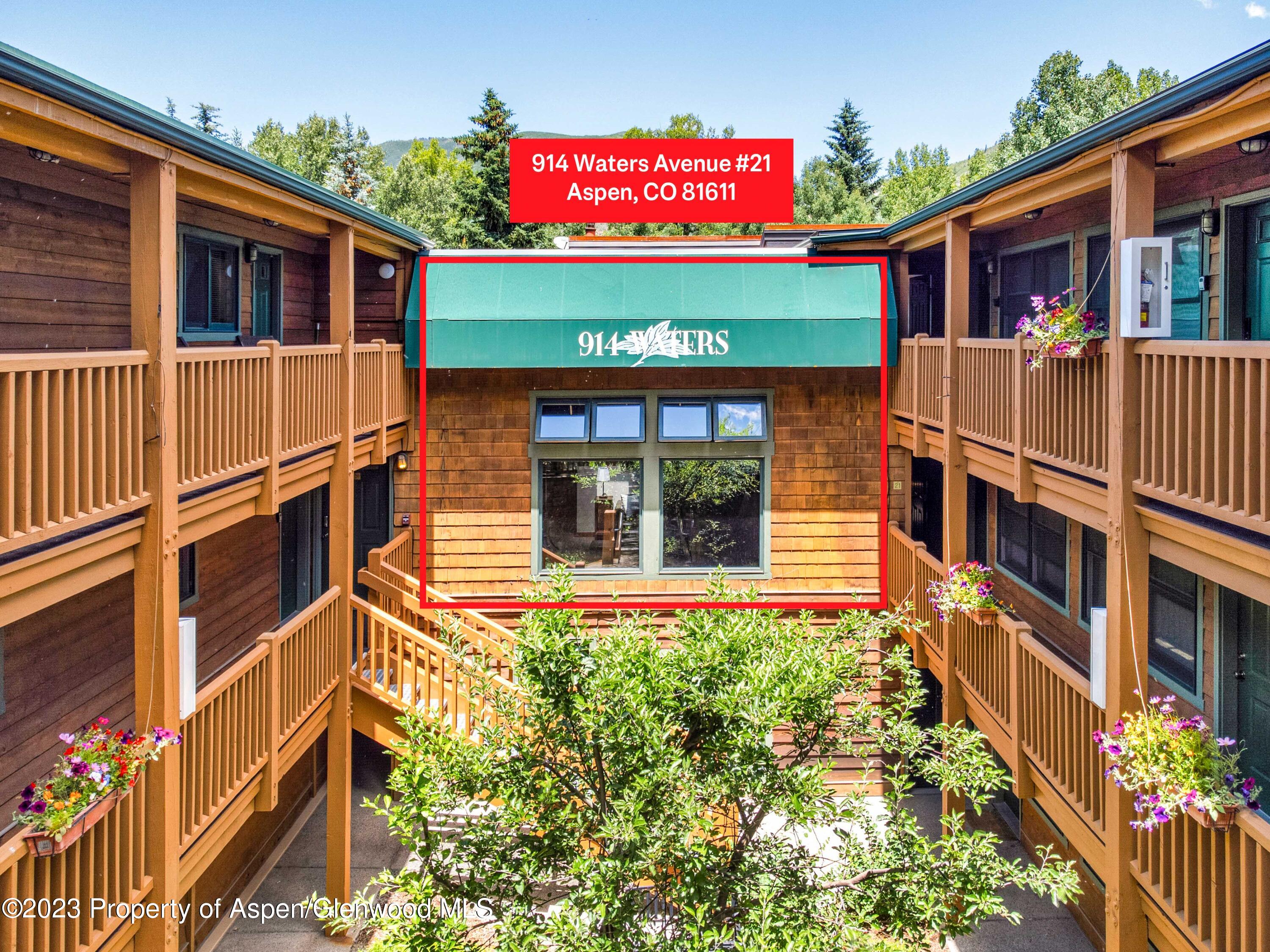 a front view of a house with plants