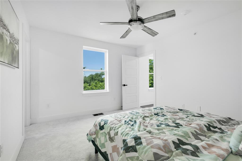 2011 Kirby Street, Unit 106 Dallas, TX 75204 - Photo 23 of 32 Bedroom with light colored carpet and ceiling fan