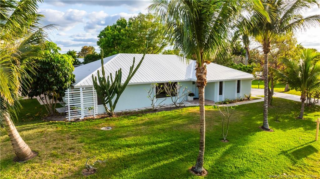 2556 Captiva Cove Stuart, FL 34994 - Photo 11 of 68 a view of a house with a yard and sitting area