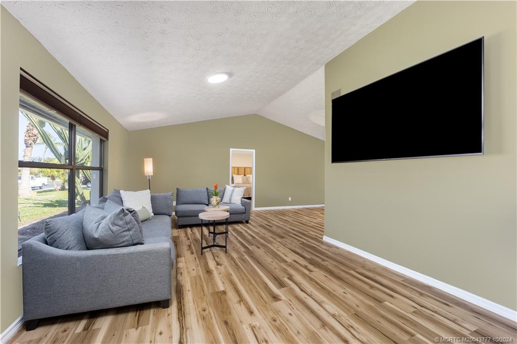 2556 Captiva Cove Stuart, FL 34994 - Photo 24 of 68 a living room with furniture and a flat screen tv