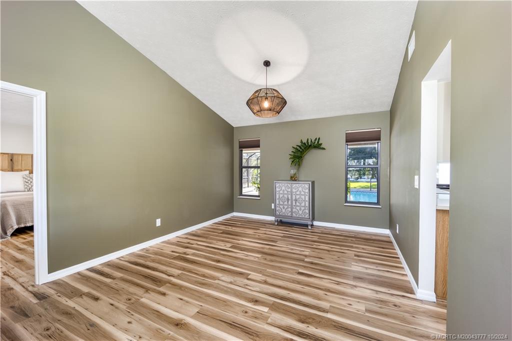 2556 Captiva Cove Stuart, FL 34994 - Photo 26 of 68 a view of an empty room with window and wooden floor