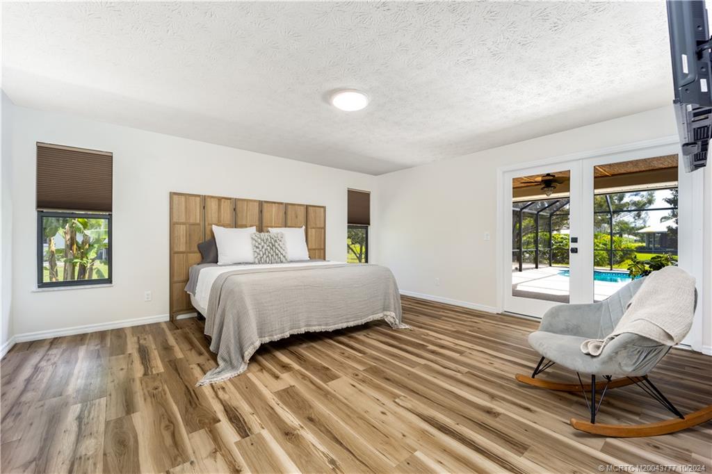 2556 Captiva Cove Stuart, FL 34994 - Photo 30 of 68 a bed sitting in a bedroom next to a window