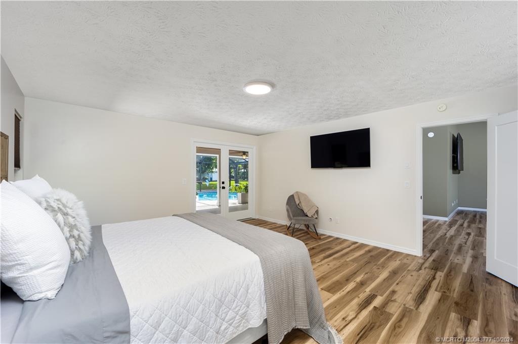 2556 Captiva Cove Stuart, FL 34994 - Photo 31 of 68 a bedroom with a bed tv and a window