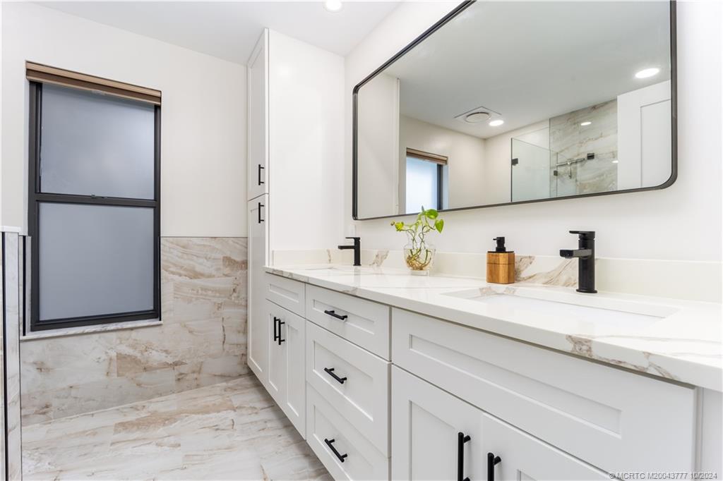 2556 Captiva Cove Stuart, FL 34994 - Photo 32 of 68 a kitchen with stainless steel appliances granite countertop a sink and a refrigerator
