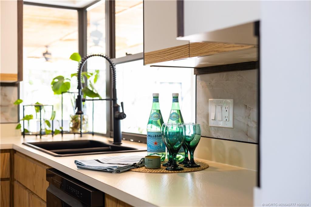 2556 Captiva Cove Stuart, FL 34994 - Photo 46 of 68 a vase of flowers sitting on a table with chandelier