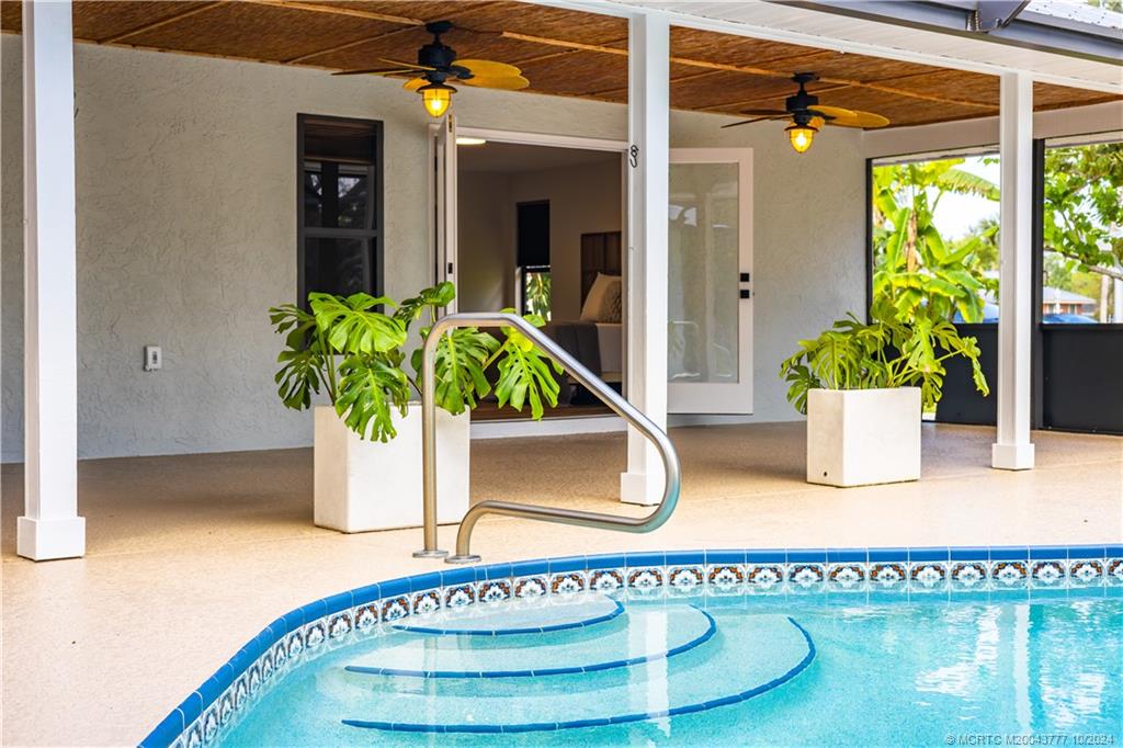 2556 Captiva Cove Stuart, FL 34994 - Photo 64 of 68 a potted plant sitting on a table next to a blue building