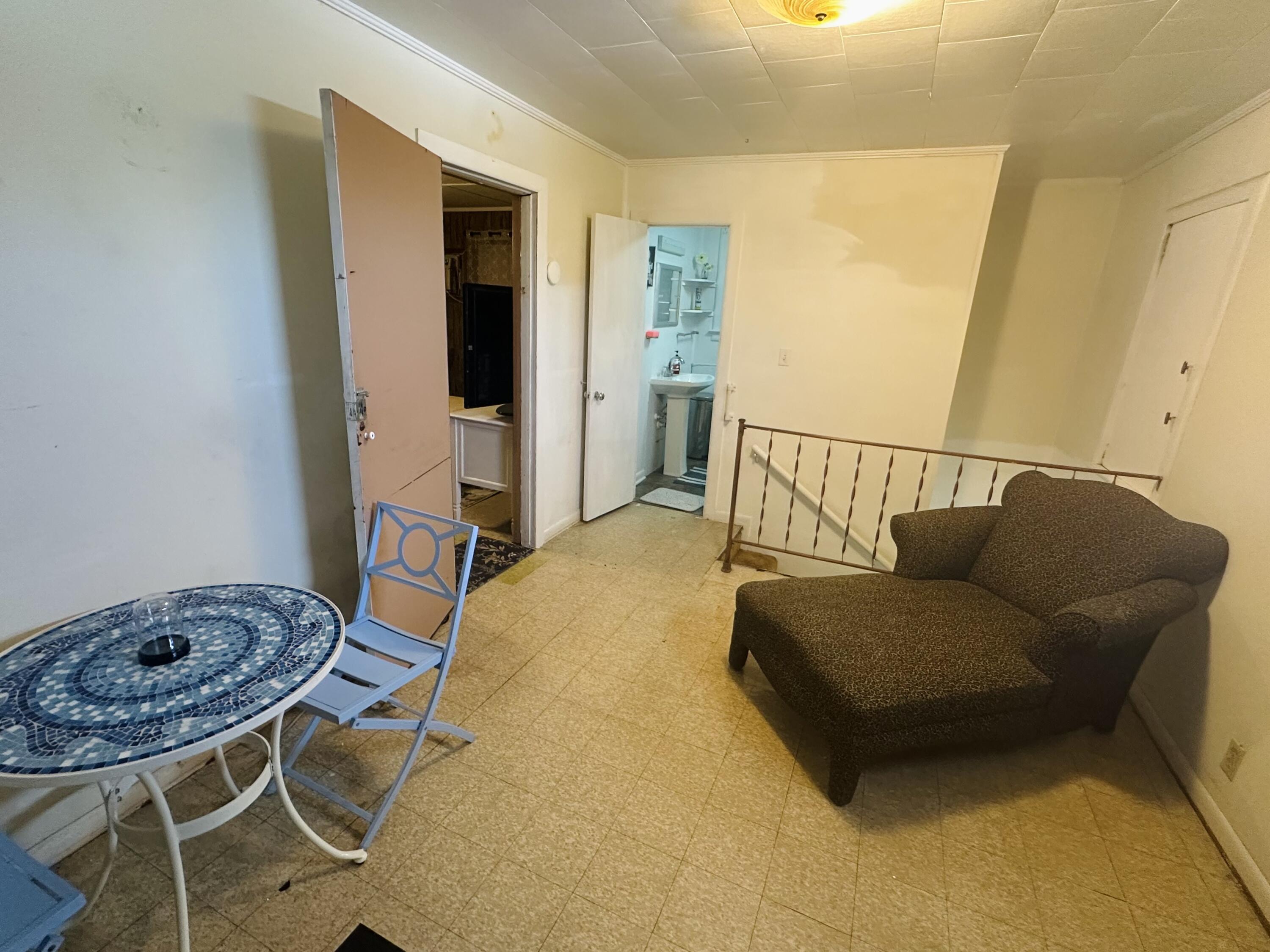 1105 Watson Street Key West, FL 33040 - Photo 11 of 26 a bedroom with a bed and chair