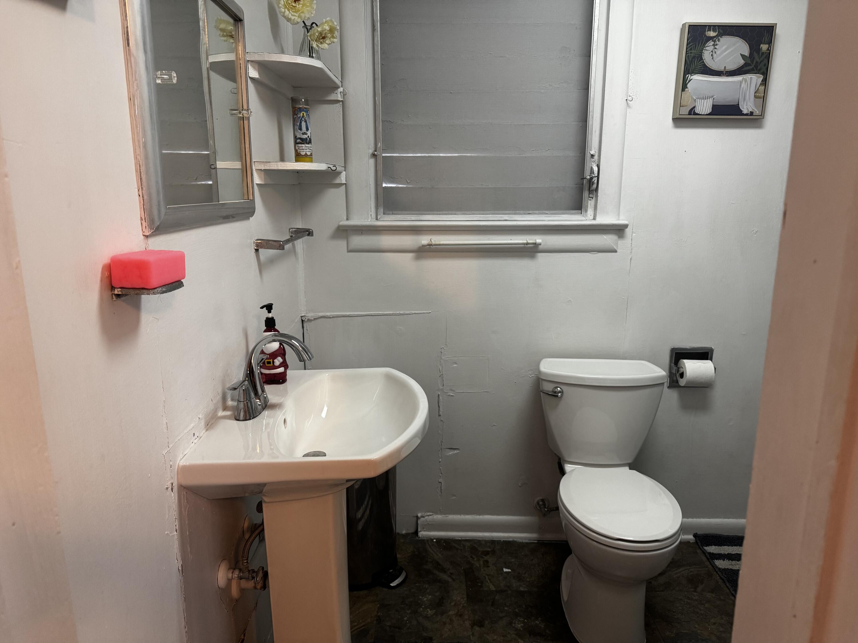 1105 Watson Street Key West, FL 33040 - Photo 13 of 26 a bathroom with a sink toilet and a mirror