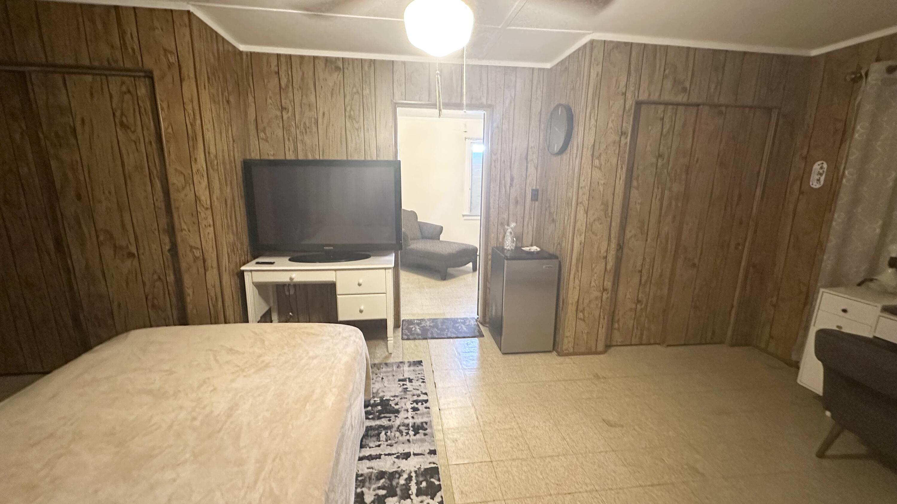 1105 Watson Street Key West, FL 33040 - Photo 14 of 26 a bedroom with a bed and a flat screen tv