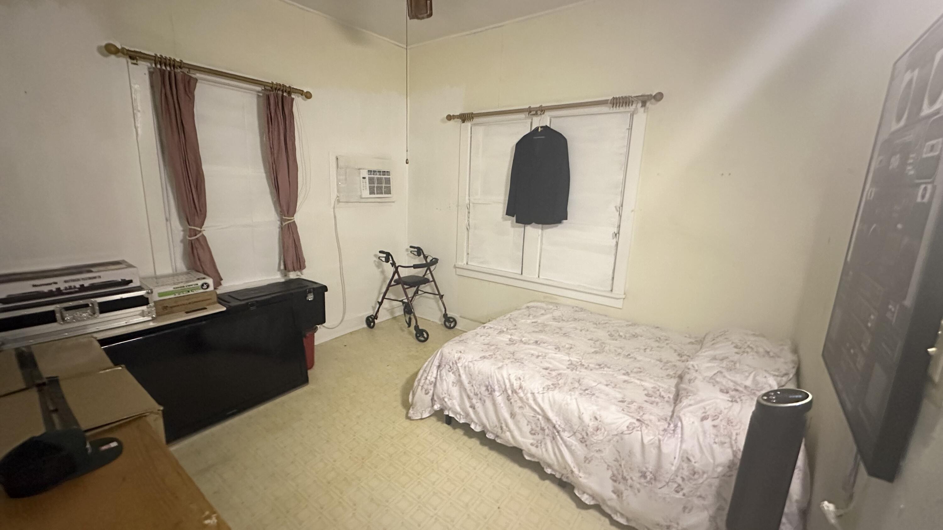 1105 Watson Street Key West, FL 33040 - Photo 21 of 26 a bedroom with a bed and a mirror