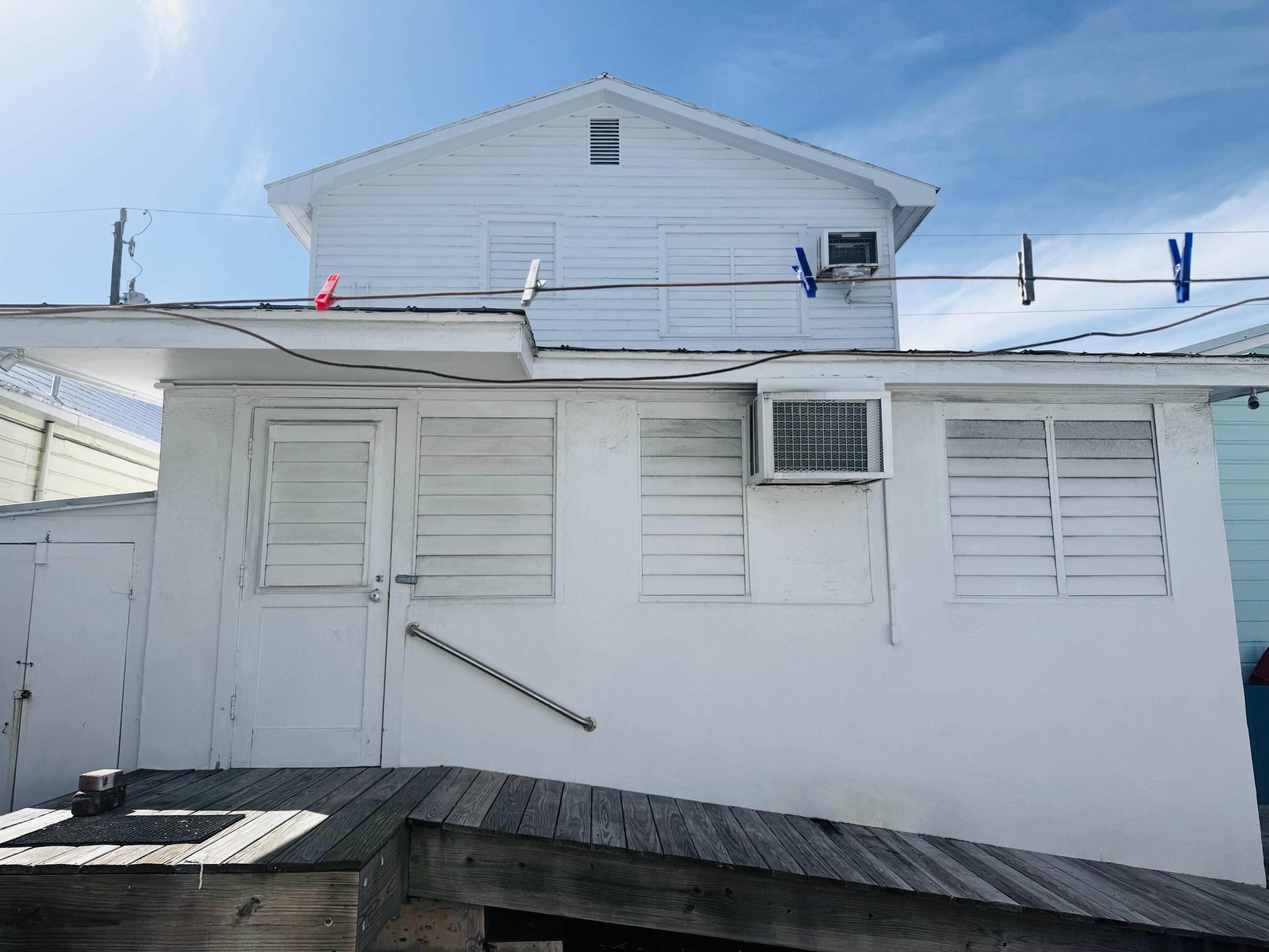 1105 Watson Street Key West, FL 33040 - Photo 23 of 26 a kitchen with kitchen island a sink and wooden cabinets