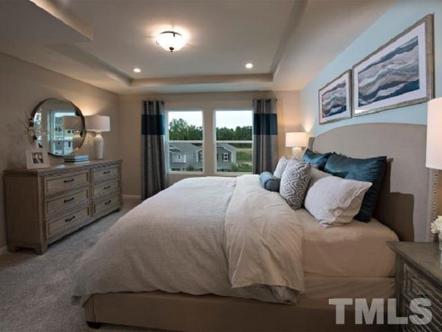 409 Diversity Way Raleigh, NC 27610 - Photo 10 of 13 a bedroom with a large bed and a window