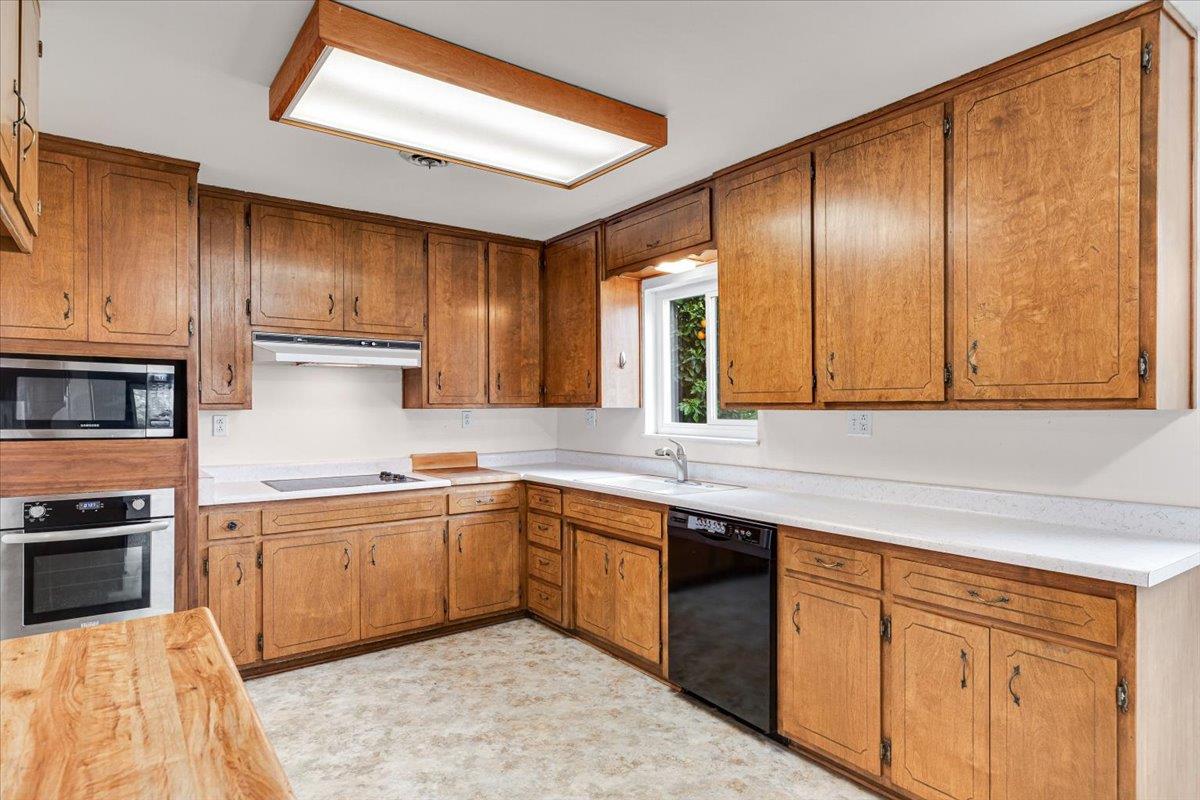 2679 Lobo Avenue Merced, CA 95348 - Photo 29 of 88 a kitchen with stainless steel appliances granite countertop wooden cabinets a sink and dishwasher a refrigerator