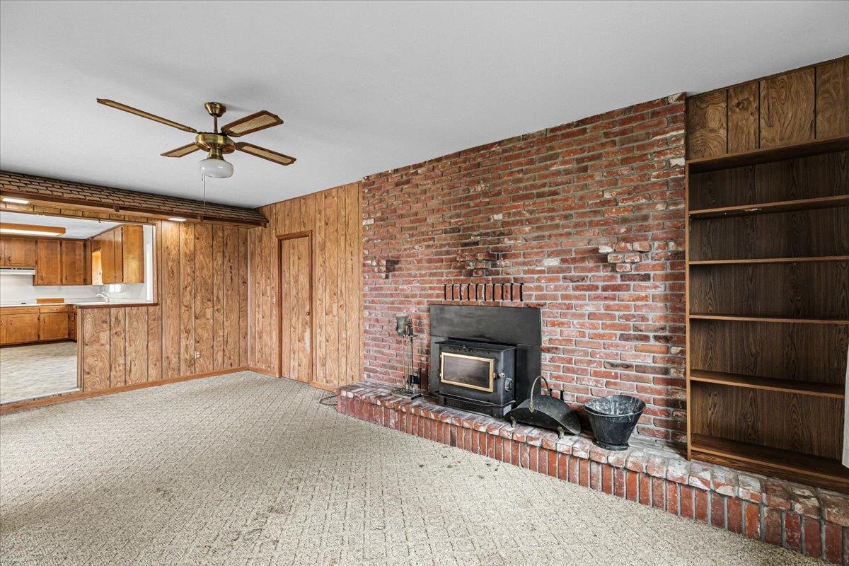 2679 Lobo Avenue Merced, CA 95348 - Photo 38 of 88 a living room with furniture a flat screen tv and a fireplace