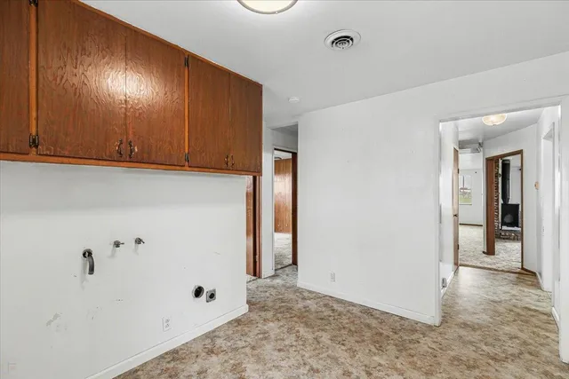 an aerial view of residential house with outdoor space and trees all around