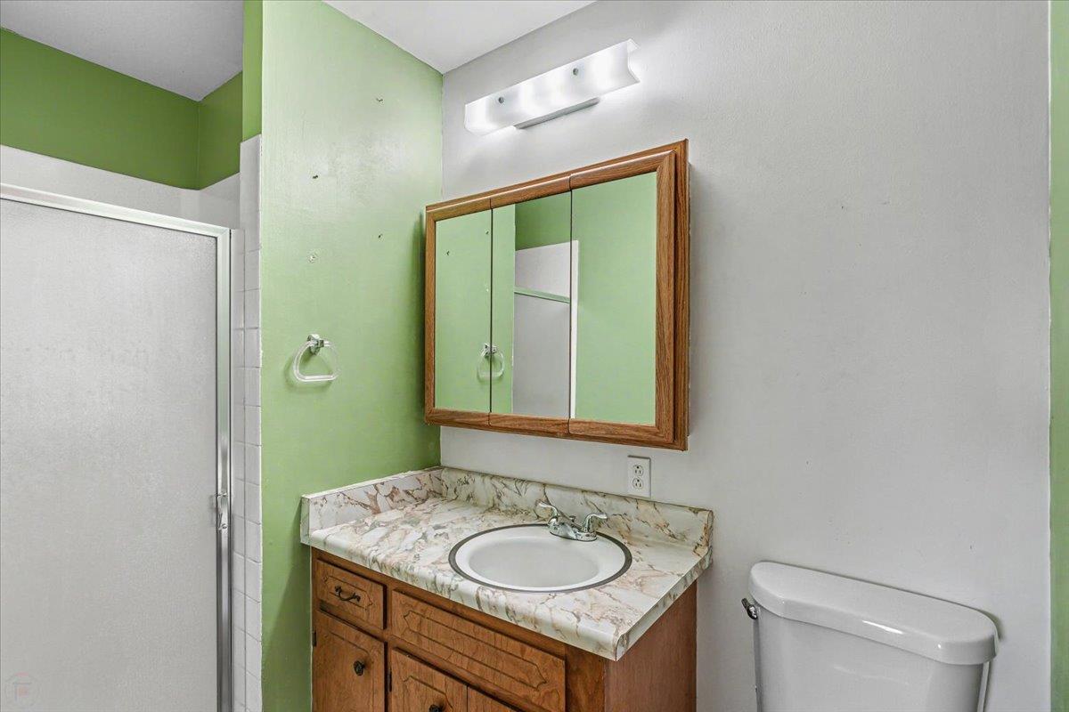 2679 Lobo Avenue Merced, CA 95348 - Photo 47 of 88 a bathroom with a granite countertop sink toilet and mirror