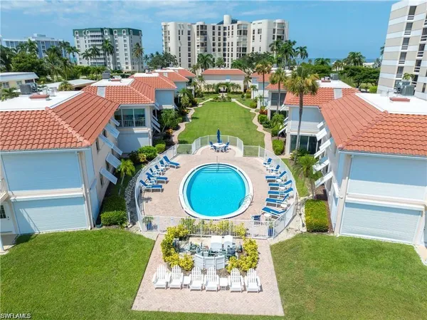 an aerial view of a house with a swimming pool outdoor seating and yard