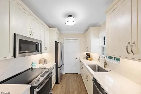 a dining room with furniture a chandelier and wooden floor