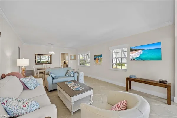 a living room with furniture and a lamp