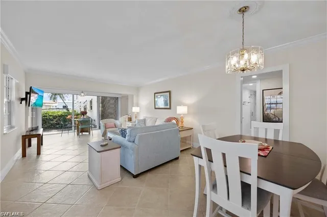 a living room with furniture a rug and a lamp