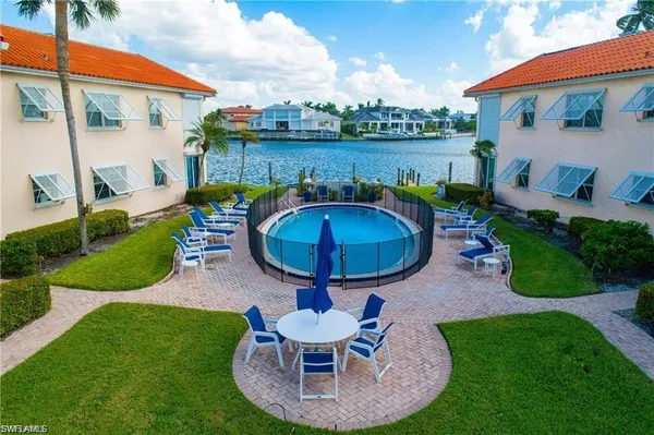 an aerial view of swimming pool having outdoor seating