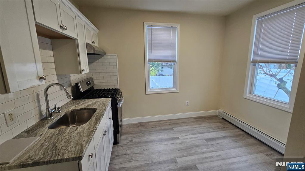 164 Humboldt Street East Rutherford, NJ 07073 - Photo 3 of 12 a kitchen with a sink a stove and cabinets