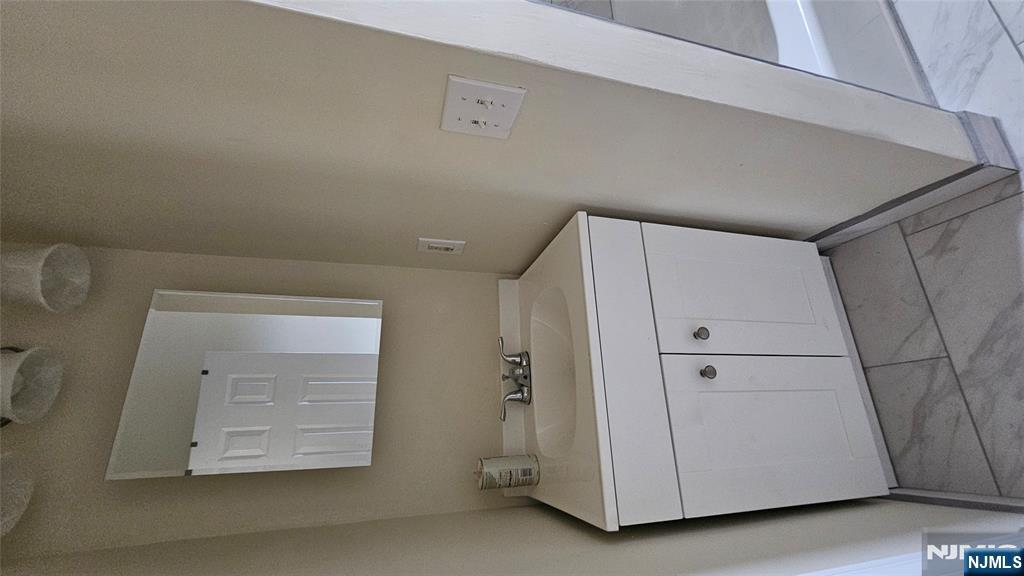 164 Humboldt Street East Rutherford, NJ 07073 - Photo 4 of 12 a bathroom with a sink and a mirror