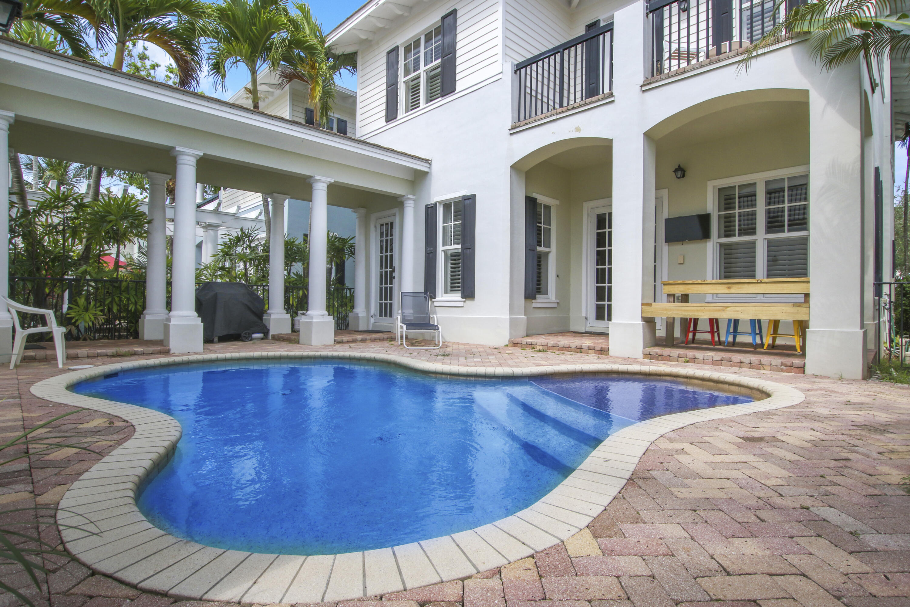 108 Spikerush Road Jupiter, FL 33458 - Photo 2 of 9 a view of a house with swimming pool and porch