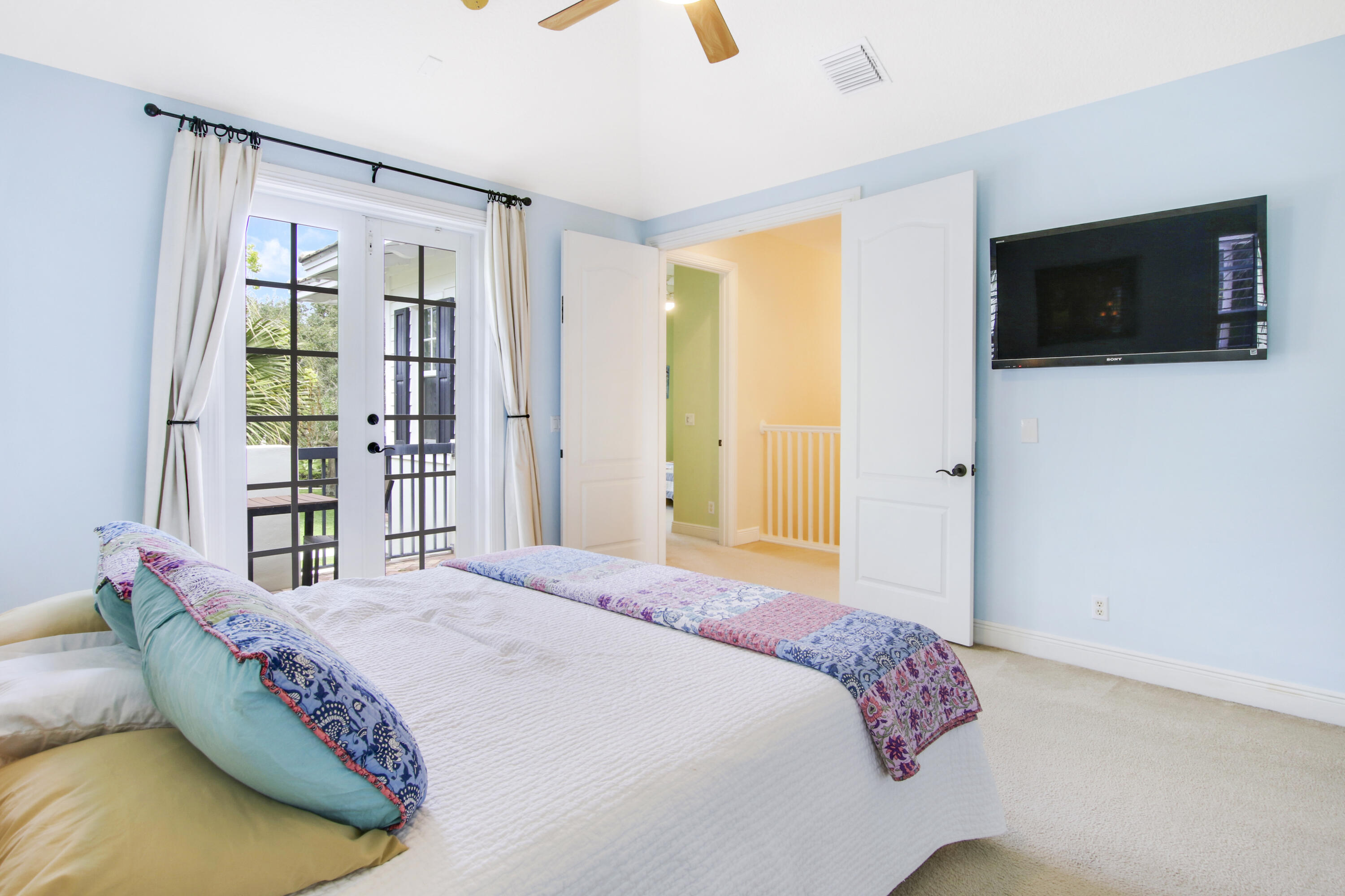 108 Spikerush Road Jupiter, FL 33458 - Photo 5 of 9 a bedroom with a bed and a television