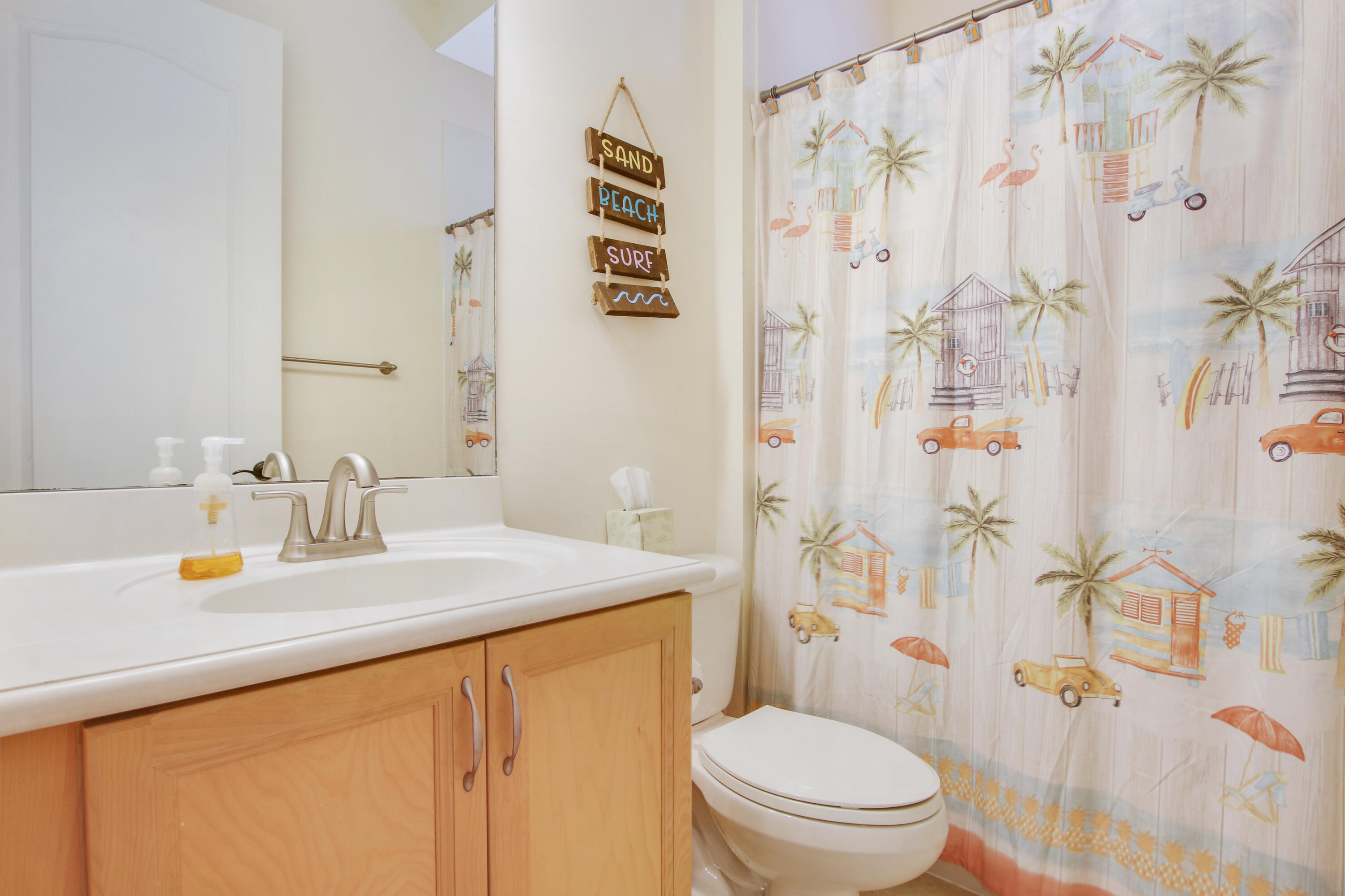 108 Spikerush Road Jupiter, FL 33458 - Photo 7 of 9 a bathroom with a sink a toilet and shower curtain
