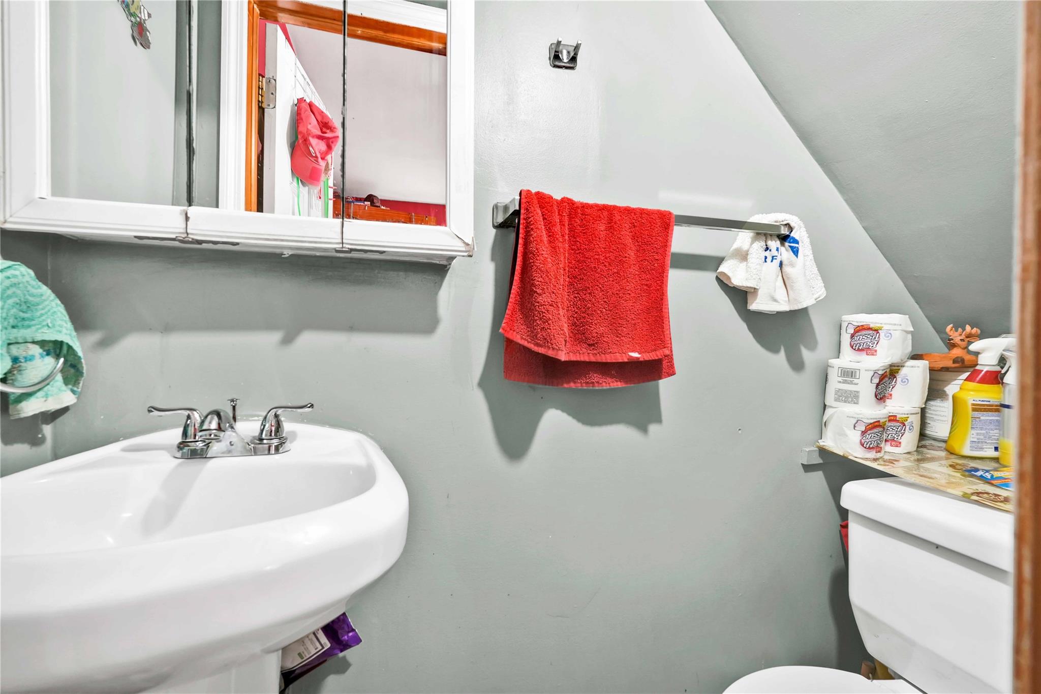 104-55 128th Street Queens, NY 11419 - Photo 4 of 12 a bathroom with a sink toilet and a mirror