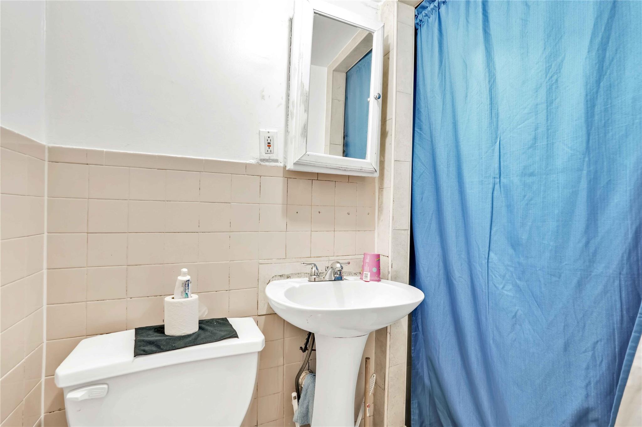 104-55 128th Street Queens, NY 11419 - Photo 10 of 12 a bathroom with a sink and a mirror