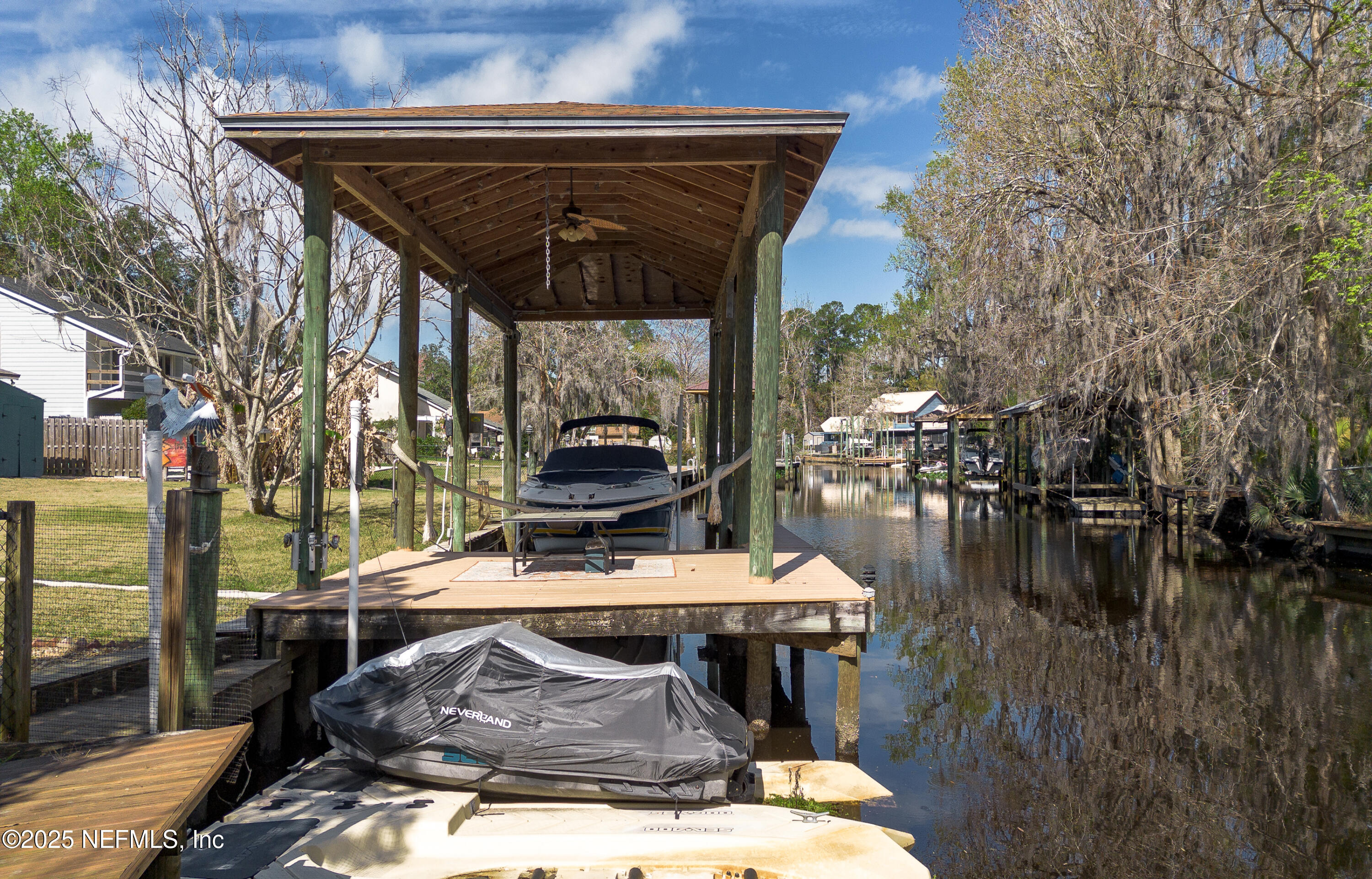 6433 River Point Drive Fleming Island, FL 32003 - Photo 58 of 76 a view of a roof deck with table and chairs a barbeque